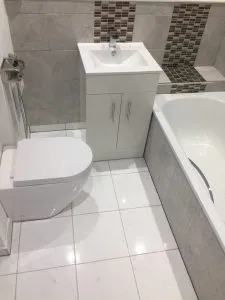 Stylish modern shower with white tiling in a recently renovated bathroom in Leyton