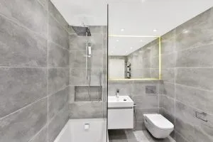 Basement bathroom renovation with bright contemporary design.