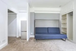Studio flat renovation in Kensington with sofa wall bed.