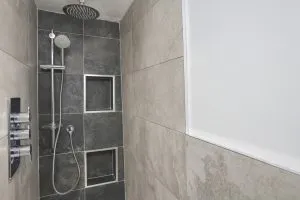 Family bathroom renovation in Sydenham with feature wall and waterfall shower