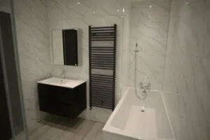 Bathroom relocation in Forest Gate with bath, shower, vanity, and toilet