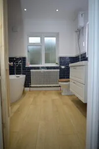 Bathroom renovation Plaistow with blue metro tiles and freestanding bath